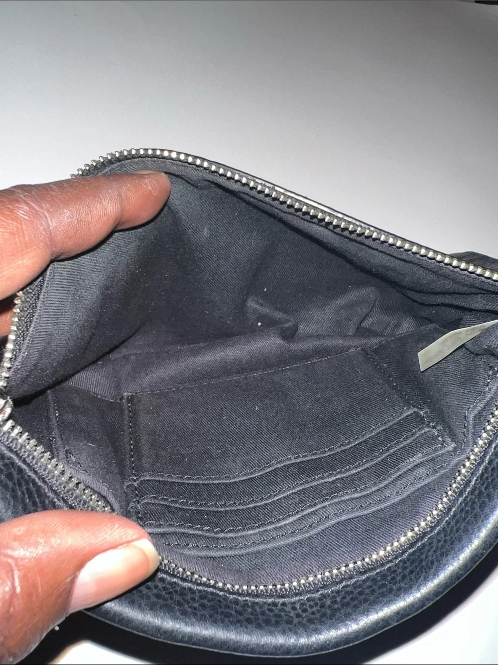 Coach Black Pebbled Leather Wristlet featuring silver hardware and a top zipper.